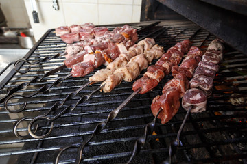 skewers of meat on the grill