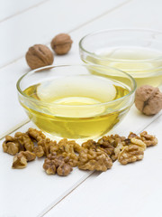 Walnut oil on white wooden background