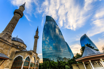 Turkish mosque of the Martyrs and modern glass central business district skyscrapers in the sunset,...