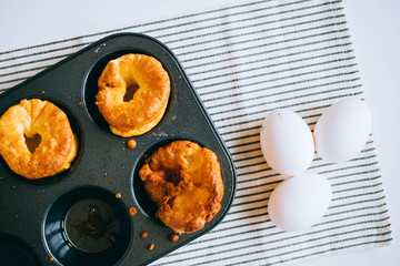 Yorkshire puddings with fish filling, in an old metal tray, top view