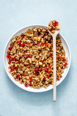 Butter pecan granola on light blue background. Top view, space for text. 