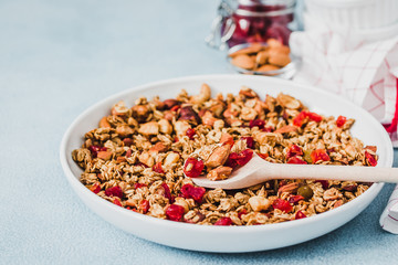Cinnamon applesauce granola on light blue background. Selective focus, copy space.