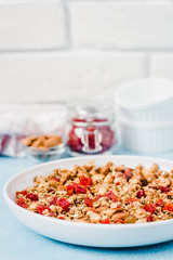 Vegan gluten free chai spice granola on light blue background. Selective focus, copy space.