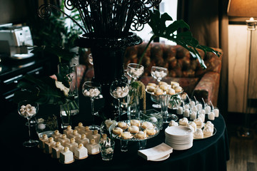 elegant dessert table at the wedding. black decoration