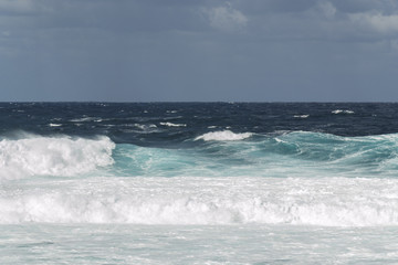 Rough turquoise sea with big waves and surf at La Santa, Lanzarote, Canary Islands, Spain