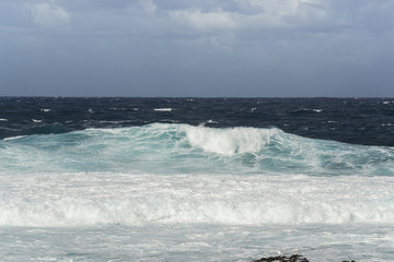 Rough turquoise sea with big waves and surf at La Santa, Lanzarote, Canary Islands, Spain