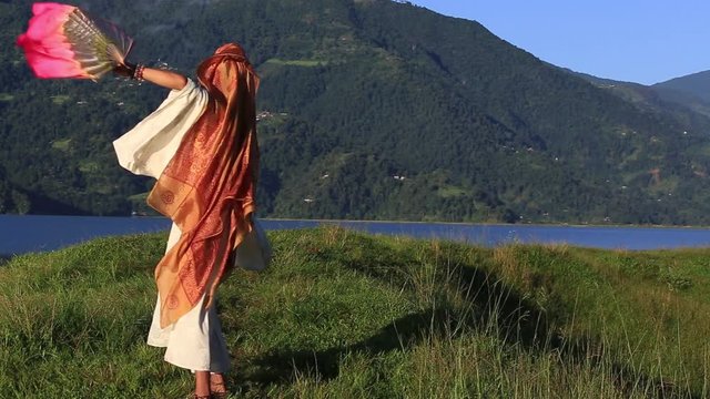 Sirena Sabiha dancing with a fan at sunrise in Pokhara, Nepal. Sirena was born in the Philippines. Close up