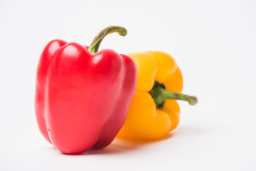 red and yellow fresh bell peppers, on white background