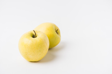 raw apples laying on white background