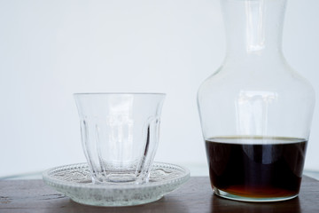 Serving coffee Hario v60 in a jug for smell, wooden. The background is blurred, all white. Side view with copy space
