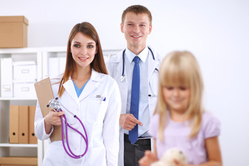 Fototapeta premium Female doctor examining child with stethoscope at surgery