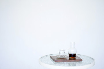 Serving coffee Hario v60 in a jug for smell, wooden. The background is blurred, all white. Side view with copy space