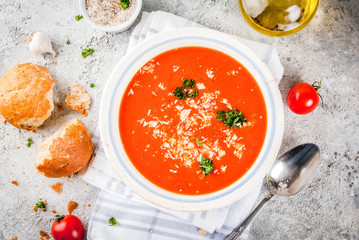 Tomato soup, Gazpacho in white bowl on grey stone background, with ingredients Top view. Copy space