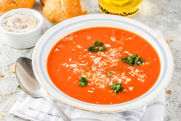 Tomato soup, Gazpacho in white bowl on grey stone background, with ingredients  Copy space