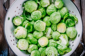 Fresh organic Brussels sprouts in a colander