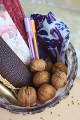Composition with walnuts in glass vase on light background