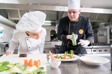 Chef Cooking, Cutting and preparing next plate