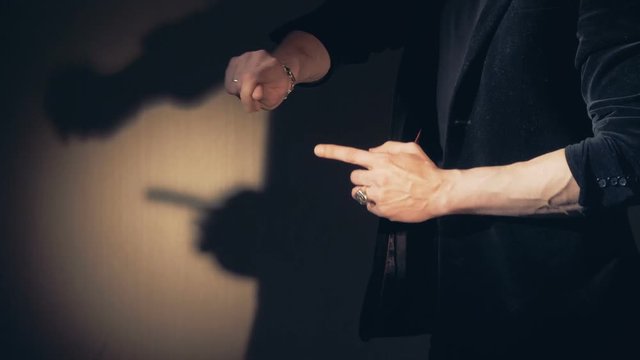 Professional magician performs Impressive trick with a ball.
