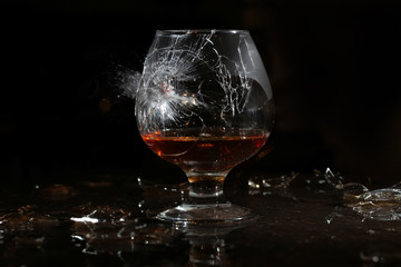 Red ball smashes a glass of cognac