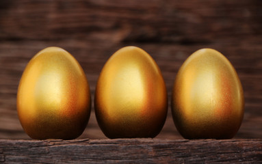 gold egg easter on old wood background