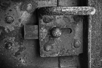 Old rusted lock mounted on steel door