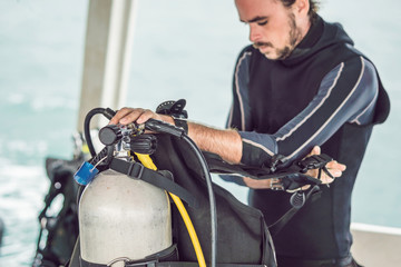 Diver prepares his equipment for diving in the sea