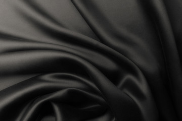 Elegant black satin silk with waves, abstract background