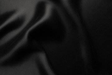 Fototapeta na wymiar Elegant black satin silk with waves, abstract background
