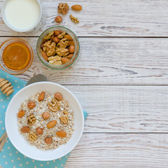 Healthy breakfast of muesli with nuts, honey and milk