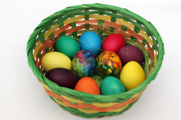 Easter eggs. Handmade painted eggs in basket for Easter celebration isolated on white background. Easter. Colored Easter eggs. Colorful egg. Copy space. Text space. Unique handmade painted eggs.