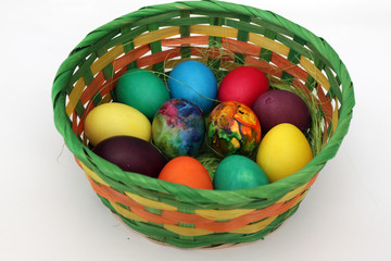 Easter eggs. Handmade painted eggs in basket for Easter celebration isolated on white background. Easter. Colored Easter eggs. Colorful egg. Copy space. Text space. Unique handmade painted eggs.
