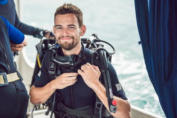 Diver prepares his equipment for diving in the sea