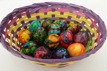 Easter eggs. Handmade painted eggs in basket for Easter celebration isolated on white background. Easter. Colored Easter eggs. Colorful egg. Copy space. Text space. Unique handmade painted eggs.