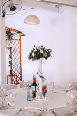 Table for guests at the wedding ceremony in decorative decoration.