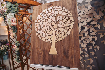 Wooden canvas with decorative elements. Deveraux in the shape of a heart at a wedding ceremony