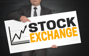 Stock exchange poster is held by businessman