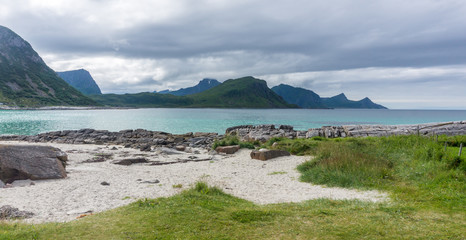 Rocky shore, sandy beach with turquoise water, Lofoten, Norway