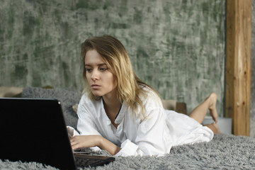 young beautiful girl working on computer at home