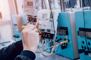 Electrician worker checking electricity meters. Electrical equipment.