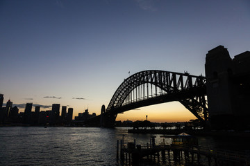Obraz premium A silhouette of Sydney harbour bridge at sunset. Sydney, Australia.