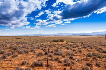 A farm fence in the Karoo. Wide open spaces, mountains and hills and a very dry climate make the...