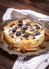 baked round cake with blueberry berries