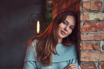 A sensual brunette in a gray sweater