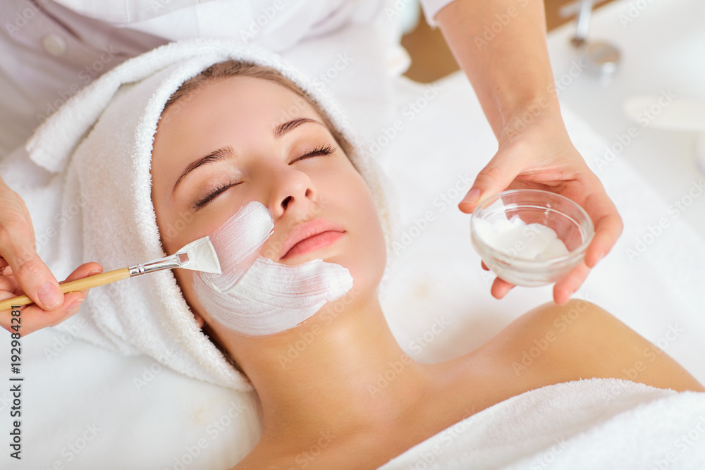 Wall mural woman in mask on face in spa beauty salon.