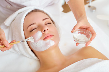 Woman in mask on face in spa beauty salon. - obrazy, fototapety, plakaty