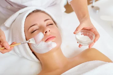 Door stickers Beauty salon Woman in mask on face in spa beauty salon.