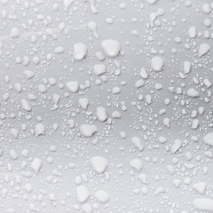 rain droplets on surface of white car body after shower