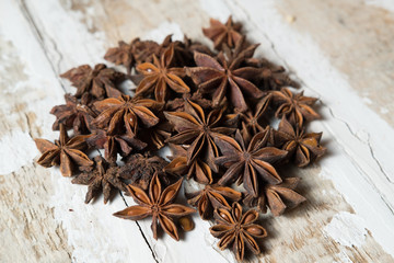 star anise is poured on a light wood surface