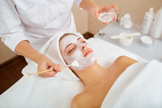 Woman in mask on face in spa beauty salon.