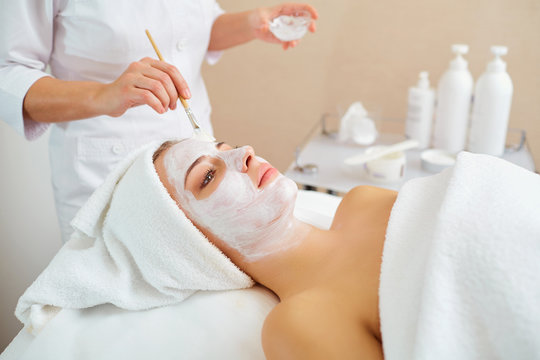 Woman in mask on face in spa beauty salon.